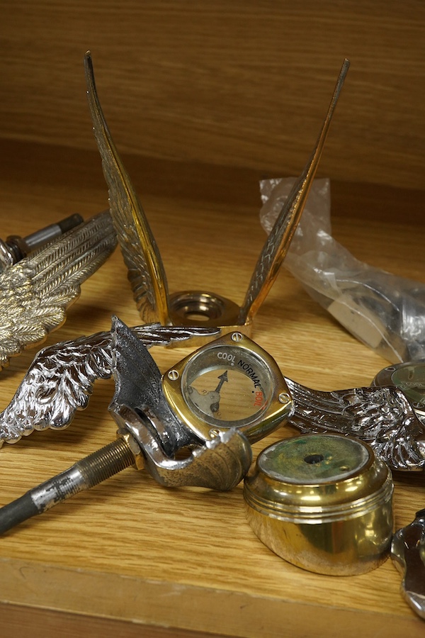 Four car mascot Calormeters by Wilmot-Breeden, three examples with winged bases, together with three additional winged bases, two radiator caps, a brass bonnet mounting, and other related fittings. Condition - fair to go